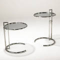 Eileen gray pair of adjustable side tables with circular glass tops on chrome frames 30 12 x 20 and 24 x 20