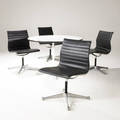 Charles and ray eames  herman miller dining suite comprising four soft pad dining chairs in vinyl and aluminum and aluminum group dining table with white laminate top with rubber edge on steel and a