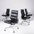 Charles and ray eames  herman miller four high back softpad armchairs on casts upholstered in black leather on polished aluminum frames with plastic coated arms 39 14 x 22 34 x 22