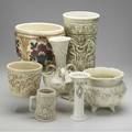 Weller box lot of seven roma and clinton ivory pieces unusual floor vase with nudes three jardinieres two vases and one mug tight line to handled vase and jardiniere reglued foot and line to foot