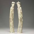 Chinese ivory tall figures of an emperor and empress the former with carved dragon decoration the latter with carved phoenix 20th c attractive patination to back on both minor loss to hair ornam