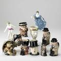 Royal doulton etc eleven pieces include two royal doulton figurines eight toby jugs and hummel umbrella boy figurine tallest 7
