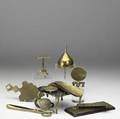 Decorative brass items twelve pieces include two miniature tilt tables two trivets two cribbage boards two shoe horns funnel tongs paperclip and magnifier all 18th19th c largest 6 x 6 x 3