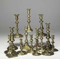 Fifteen single brass candlesticks in various styles 18th19th c tallest 10