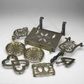Eight brass trivets in various sizes and forms all 19th c largest 10 14 x 13