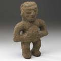 Male stone idol costa rica carved volcanic stone in proud upright posture with hands on abdomen linear treatment to hair and almondshaped eyes ad 500800 provenance private collection new yor