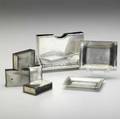 Tiffany  co silver smoking accessories card or cigarette holder on foliate feet ca 1900 together with four match cases and two ashtrays ca 1940 monograms