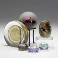 Glass paperweights group lot of six pieces including silver veiled paperweight by michael okeefe 1984 geode by richard satava with insect and sun 1993 and spherical paperweight on stand decorat