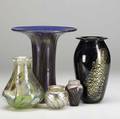 Lundberg studios  orient  flume  eickholt five glass pieces two cabinet vases and a third vase with fish by lundberg studios trumpetshaped vase by orient  flume black ovoid glass vase with gol