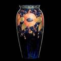 Moorcroft tall vase in the pomegranate pattern on indigo stamped moorcroft made in england 595 with green ink signature 15 x 7