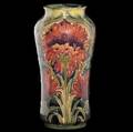 moorcroft early vase in the cornflower design in red on an ochre ground 191018 stamped moorcroft burslem england 161 and green ink signature 6 12 x 3