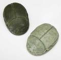 grueby two large scarab paperweights one covered in matte green glaze the other in sea foam green two chips to footring of latter both stamped with grueby faience medallion 4 x 2 12