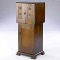 gustav stickley rare music stand designed by harvey ellis with a dovetail constructed cabinet over a paneled base the top doors inlaid with grapes and leaves the interior shelved and compartmental