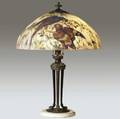 handel table lamp with a chipped glass shade reversepainted by peter broggi with parrots on blooming branches over a classical threesocket bronzed base on marble shade stamped handel lamps pat