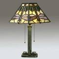 bradley  hubbard rare table lamp with a foursided mosaic type slagglass shade depicting dragonflies and lily pads on a yellow ground over a twosocket base with verdigris patina short break to o