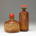 Paolo venini  venini two trailedspiral applied glass bottles in salmon and amber both marked venini murano italia 9 14 x 3 sq and 6 14 x 4 12 sq