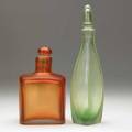 Paolo venini  venini two inciso glass stoppered bottles one in light green the other in orange both marked venini murano italia 11 34 x 3 and 7 34 x 4 12