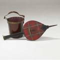 Jacques adnet firewood bucket along with black leather and red plaid bellows both with brass details 19 x 12 bellows 40 x 14