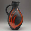 Gilbert valentin french 19282001 tall thrown ceramic pitcher covered in matte black glaze with orange enameled design signed g valentin vallauris 13 34 x 8 12 x 7