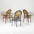 Modern set of three enameled cast iron armchairs with scrolled arms and woven raffia seats 31 x 19 x 20