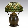 Tiffany studios table lamp with daffodil shade bronze base with floral foot electrified oil font both stamped tiffany studios new york base 189 11407 36646 18 x 14