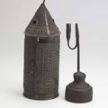 Country primitives punched and pierced tin candle lantern and a tallow holder 19th20th c taller 15