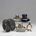 Desk accessories six pieces two bronze plaques with classical figures two lidded crystal inkwells with brass mounts porcelain inkwell with cobalt glaze and gold leaf design and art deco french the