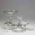 Crystal and glass nine pieces include blown glass footed bowl with greek key border and stars in the field with matching covered cheese english frosted glass footed compote cut glass bottle coaster