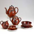 Chinese porcelain orange and black handdecorated tea set includes teapot covered sugar creamer slop bowl and five teacups with saucers tallest 7