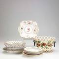 French porcelain twelve pieces include two openwork baskets with floral decorations four soft paste floral decorated plates etc