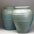 Garden pair of tall glazed terracotta oil jars with applied decoration 25 x 21 dia