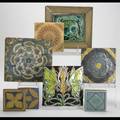 Decorative tile grouping twentytwo include relief figure and floral abstract designs and relief butterflies largest 8 12 sq