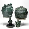 Asian pottery four pieces in a glossy green glaze spouted water vessel small creamer balustershaped incense holder covered jar 19th  20th c tallest 8 12