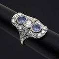 Art deco style diamond and sapphire cocktail ring platinum principal transitional cut diamond approx 50 ct flanked by two cornflower blue sapphires 12 cts tw smaller oec diamonds 13 cts t