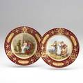 Royal vienna two handpainted plates with ruby and gilt borders one depicting alexander and apelles the other the dance of the nymphs ca 1900 signed willner beehive mark cr austria 7 34 d