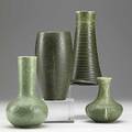 Grueby four small matte green vases minute fleck to rim of shortest ovoid vase has shaved bottom other have a variety of stamps tallest 6 12