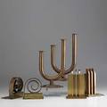 Walter von nessen chase two pairs of copper and brass bookends together with a pair of copper double candlesticks bookends stamped chase logo sticks inscribed prototype for chase by von nessen 26