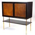 Harvey probber cabinet with two leathercovered sliding doors concealing three drawers on one side and single shelf on the other over a lower shelf on tubular brass legs probber metal tag 43 34