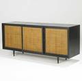 Harbey probber ebonized threedoor credenza with caned front and ebonized case concealing drawers unmarked 28 x 62 12 x 18