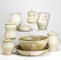 Gary baxter ten pieces of stoneware include cannister set two similar pitchers two mixing bowls and a large shallow bowl each signed tallest 10 12 x 6 12