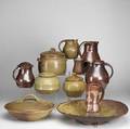 Ron brown pottery group eleven pieces include charger four covered dishes three pitchers two mugs and a covered tankard largest 4 x 18 x 18