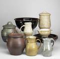 Ron brown pottery group nine pieces include three covered jars three pitchers and three bowls in assorted glazes largest 12 x 10 x 9