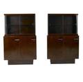 Gilbert rohde  herman miller pair of mahogany burled walnut and rosewood etageres with steel pulls and interior adjustable shelves each with glass doors and single shelf 58 x 36 x 16 12