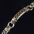 Mitchellpeck silver and 18k yg link bracelet banded arched links with x details within patinated channels marked 709 gs 7 34