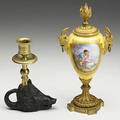Sevres style covered urn dore trim goat head handles converts to candlestick 19th c together with boars head candlestick 19th c taller 9 12