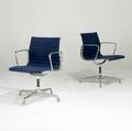Charles and ray eames for herman miller two aluminum group dining chairs with arms branded 33 12 x 23 x 22