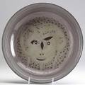Scheier glazed low bowl with a primitive portrait inscribed scheier 12 34 dia