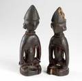 Two yoruba male ibeji twin figures nigeria africa carved wooden dolls representing twin boys with an overall abstract quality and adorned with glass beads each 11
