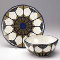Mettlach charger 2960 and faceted bowl 3364 decorated in a floral pattern in indigo brown and ivory both fully marked 4 x 8 34 and 12 dia