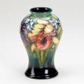 Moorcroft corseted vase decorated in the orchid pattern illegibly signed stamped made in england 6 14